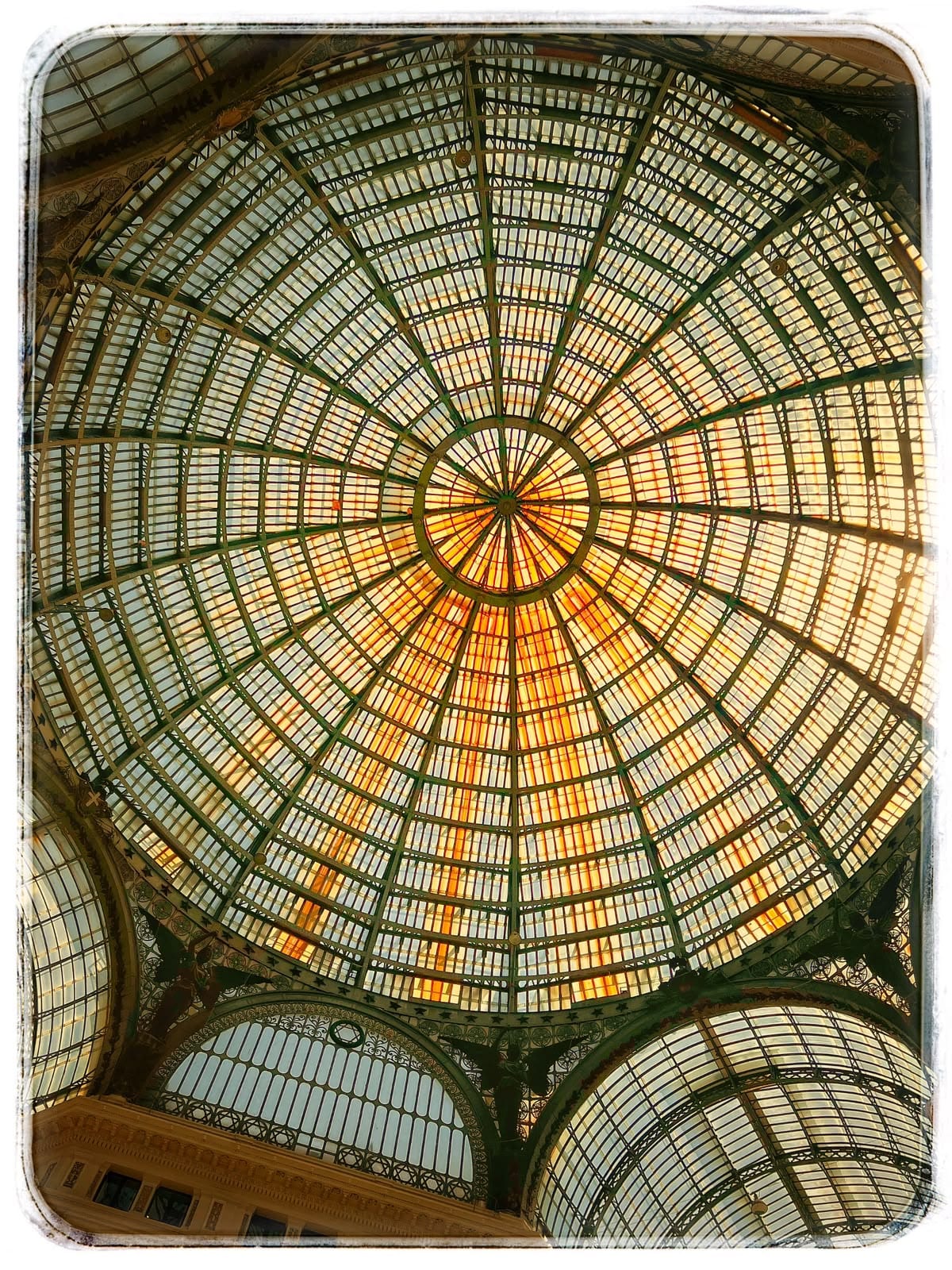 Looking straight up into the glass-and-iron dome of the Galleria Umberto I.